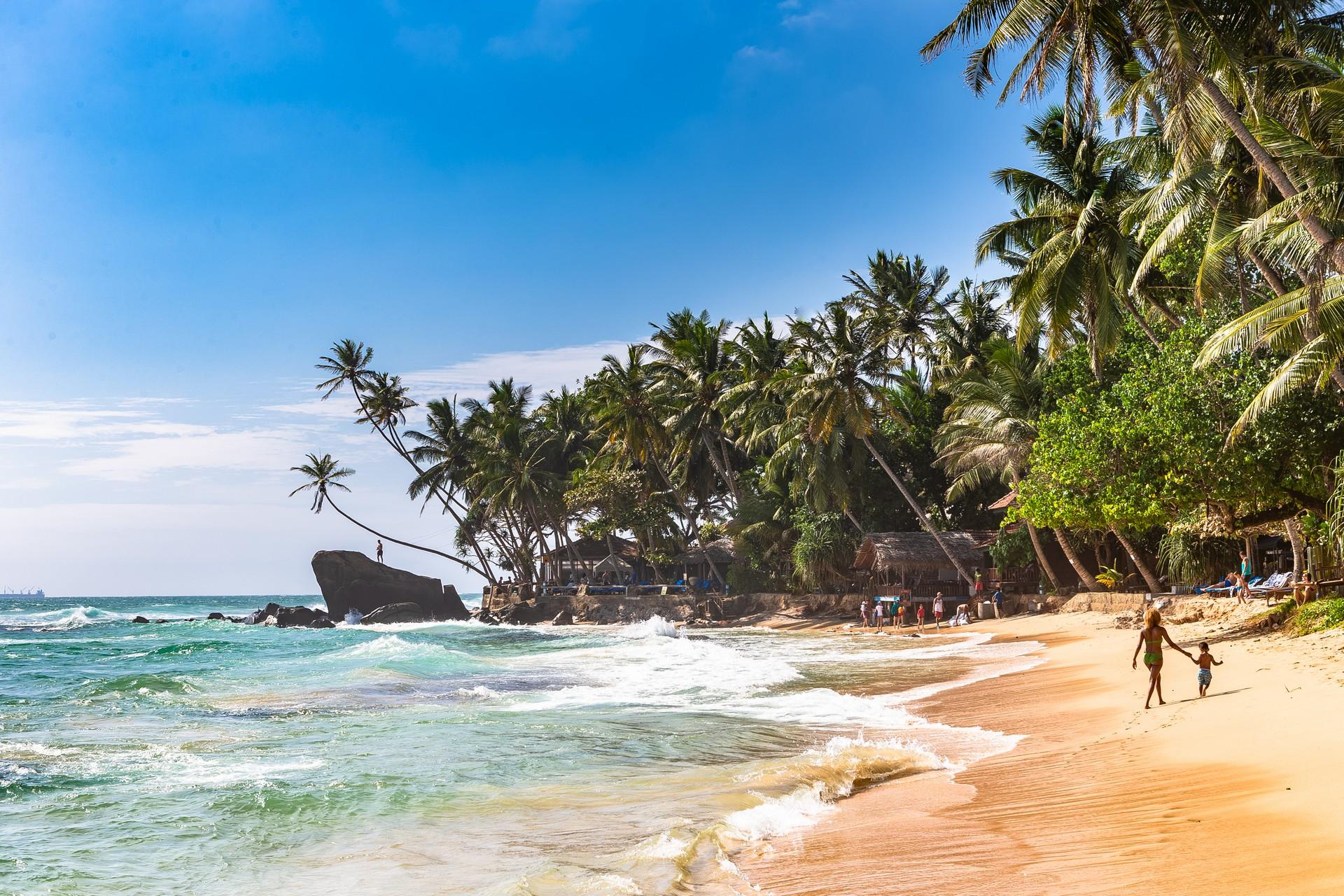 Beachfront dining and sunset views across the bay in Unawatuna